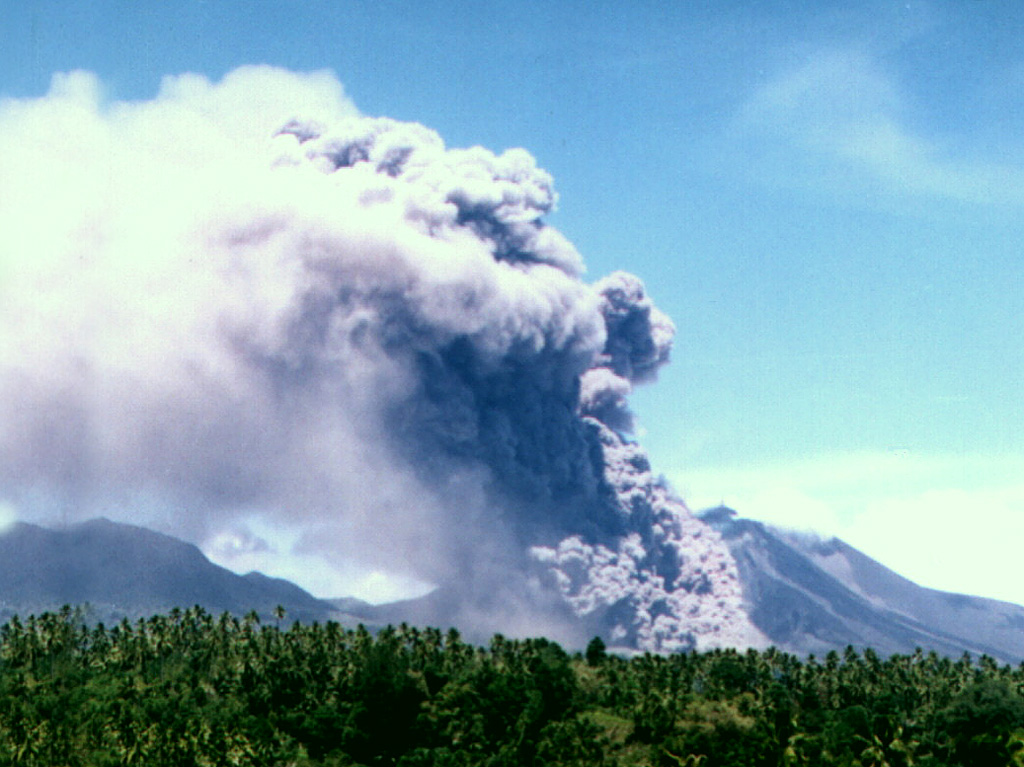 A pyroclastic flow produced by collapse of a growing lava dome descends the flank of Soputan on July 18, 2005.  Soputan erupted on April 20, 2005, with a plume reaching ~ 1 km above the summit and lava fountains rising ~ 200 m above the volcano.  MODIS thermal alerts had begun the night of the 19th.  Rapid lava dome growth occurred in April, and by 21st the lava dome had spread about 250 m E and 200 m SW.   Photo by Farid Bina, 2005 ( Directorate of Volcanology and Geological Hazard Mitigation).
