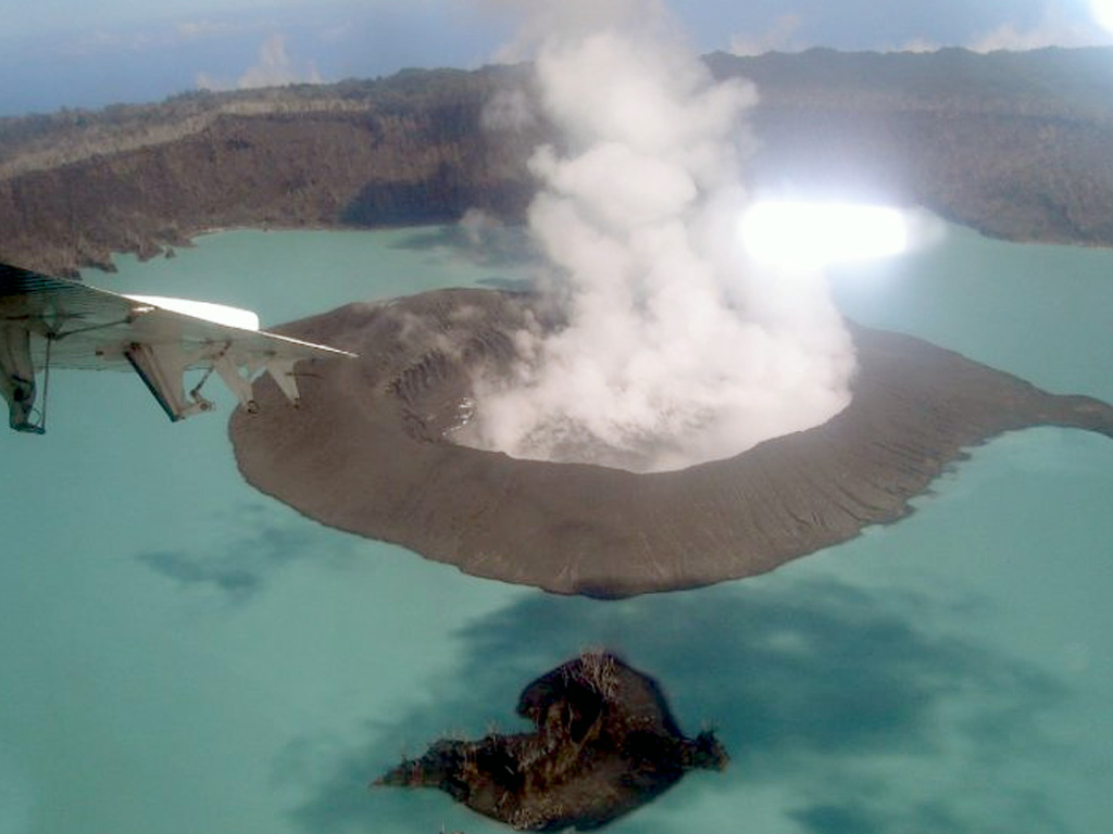 A plume rises from a crater lake inside the new island formed during an eruption at Ambae beginning on 27 November 2005. This 9 January 2006 view looks toward the N. The new island was more than 500 m wide at this time and contained an internal lake. Photo by Job Eassau, 2006 (courtesy of Esline Garaebiti, Dept of Geology, Mines, and Water Resources, Port Vila).