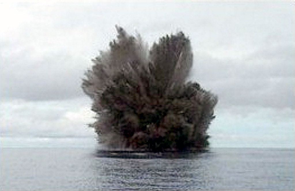 A cock’s-tail plume rises above Kavachi volcano during a Surtseyan eruption on 15 March 2004. Projections of individual blocks and ash can be seen at the margins of the plume. The frequently-erupting submarine volcano had been inactive since August 2003. Photo by Corey Howell, 2004.