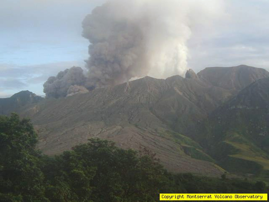 An ash cloud rises above the southeastern slopes of Soufrière Hills volcano on November 24, 2005.  After a quiescent period of almost a year, ash eruptions had resumed at Soufrière Hills on April 15, 2005.  Intermittent explosive eruptions continued, and pyroclastic flows were first reported on June 28.  Renewed lava dome growth was first observed on August 6.  Dome growth and explosive activity continued into the following year. Photo courtesy of Montserrat Volcano Observatory, 2005.