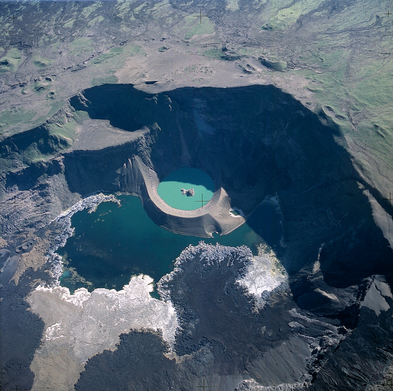 A near vertical aerial photo shows the caldera of Cerro Azul with north to the lower left.  The lava flow extending into the caldera lake from the bottom of the image was erupted in September 1998.  Lava flows were erupted in September and October 1998 from vents on the south caldera bench and west caldera floor.  Another vent from a radial fissure at 630-680 m elevation on the SE flank produced a lava flow that reached to within about 2 km of the ocean.   Photo by Patricio Ramon, 2003 (Instituto Geofisca, Escuela Politecnica Nacional).