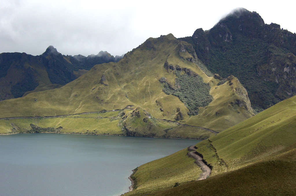 Laguna Grande de Mojanda occupies the caldera of Mojanda volcano, one of the largest volcanoes of Ecuador's northern Interandean Depression.  This view looks toward the rugged eastern rim of the caldera from the slopes of the post-caldera stratovolcano Fuya Fuya with Cerro Negro at the upper right.  Laguna Grande de Mojanda is one of two lakes occupying a summit caldera cutting an older Mojanda edifice.  Fuya Fuya volcano was constructed immediately to the west of Mojanda and produced two major rhyolitic plinian explosive eruptions. Photo by Lee Siebert, 2006 (Smithsonian Institution).