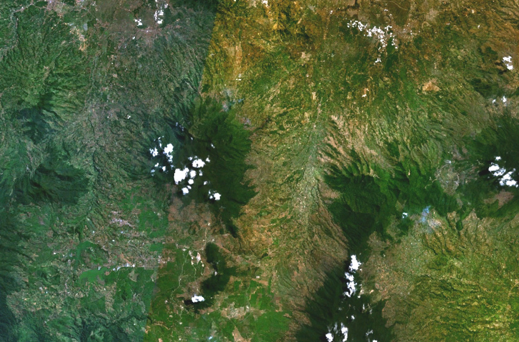 The forested Gunung Malabar stratovolcano is the dark-green, partially cloud-covered area (left-center) in this composite NASA Landsat image of western Java (with north to the top).  Malabar lies immediately south of the major city of Bandung, partially visible at the top left.  The broad, 2343-m-high basaltic-andesite Malabar volcano rises north of Wayang-Windu lava dome (the elongated dark-green area), west of Kawah Kamojang and Guntur volcanoes (right-center), and NW of Kendang volcano (bottom right-center). NASA Landsat 7 image (worldwind.arc.nasa.gov)
