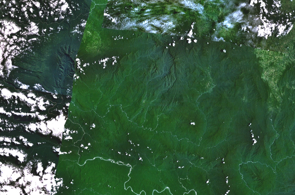 The broad depression above the center of this composite NASA Landsat image of Papua New Guinea (with north to the top) is Crater Mountain.  Although this arcuate chain of peaks 3000 m or more in height is extensively eroded, steep-sided valleys to the north and east are floored by lava flows and other young volcanic features.  The Purari River cuts across the bottom of the image, and the smaller Pio River parallels it to the north, south of Crater Mountain.  NASA Landsat 7 image (worldwind.arc.nasa.gov)