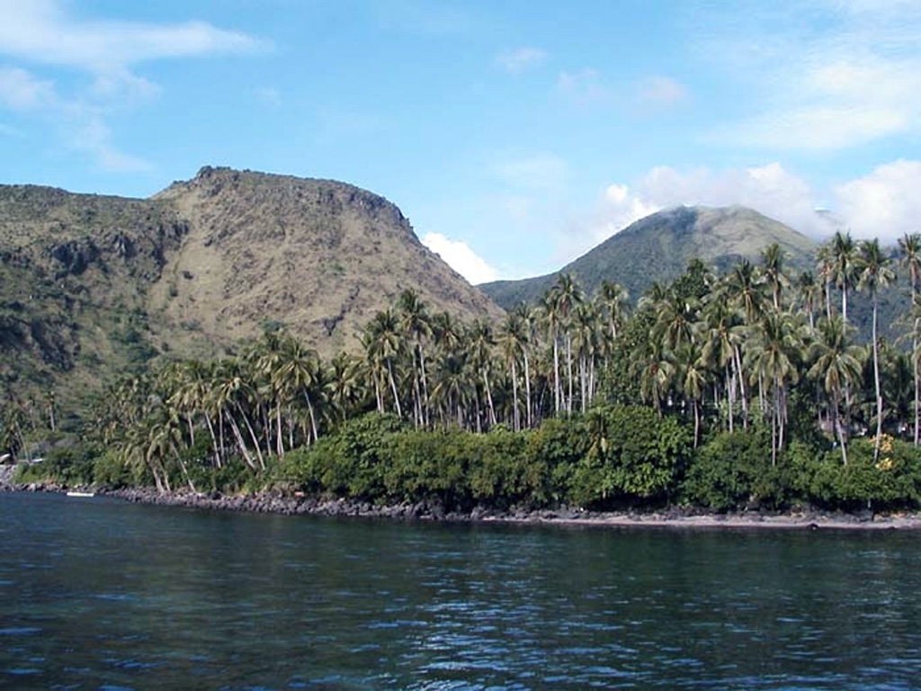 Mt. Vulcan (left) and Hibok-Hibok (right) are two historically active lava domes on Camiguin Island. These two domes were active in the 19th and 20th centuries, with Mt. Vulcan forming in 1871. Several historical eruptions have occurred at Hibok-Hibok with the most recent during 1948-1953, when pyroclastic flows devastated island villages. The 20-km-long Camiguin Island lies just off the coast of north-central Mindanao Island and consists of four overlapping volcanoes and flank lava domes. Photo by Juny La Putt, 2002.