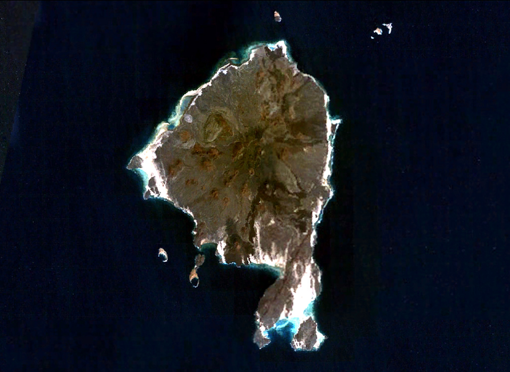 Zukur (Zugar), the northernmost large island of the Zukur-Hanish island group in the southern Red Sea, is seen in this NASA Landsat image (with north to the top). Numerous young basaltic spatter cones were the source of pahoehoe lava flows. Products of phreatic eruptions at Zukur form small islands, such as Shark and Near Islands off the SW coast of Zukur. Vents on Zukur are aligned along a NE-SW trend, as seen on the peninsula at the southern tip of the island. NASA Landsat 7 image (worldwind.arc.nasa.gov)