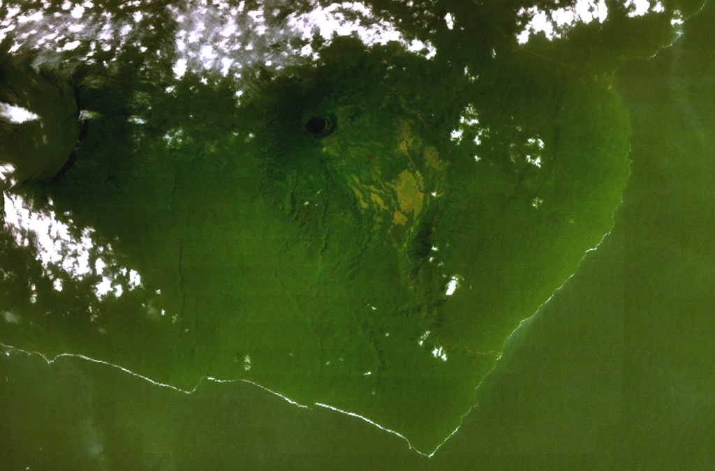 A dark-colored lake partially fills a small caldera (top-center) occupying the summit of San Joaquin volcano in this NASA Landsat view with north to the top. This basaltic shield volcano, also known as Pico Biao, lies on the SE side of Bioko (Fernando Poo) Island in the Gulf of Guinea. Part of the broad summit caldera of neighboring San Carlos volcano can be seen at the left. NASA Landsat 7 image (worldwind.arc.nasa.gov)