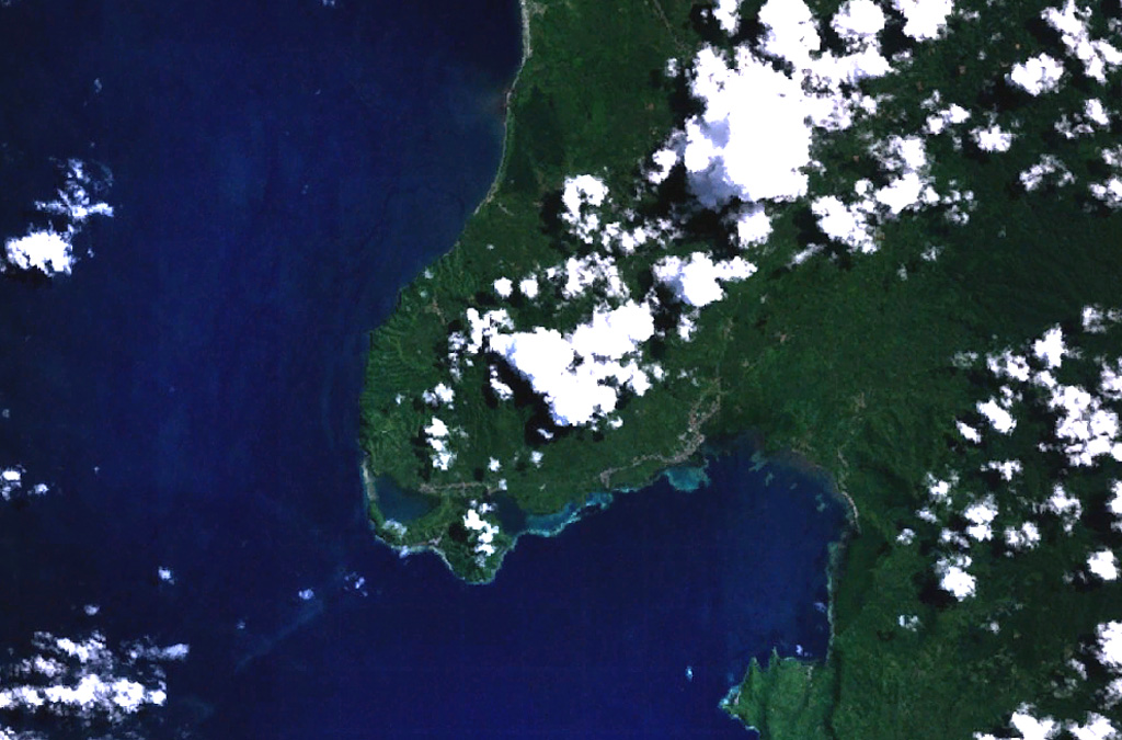 The Jailolo volcanic complex (center) forms a roughly 10-km-long peninsula west of Jailolo Bay (bottom-right) in this NASA Landsat image (with north to the top).  Jailolo stratovolcano in the center of the complex is flanked by small calderas to the west and SW.  Kailupa cone forms the east side of the small island off the southern coast of the peninsula.  Hot mudflows were reported from Jailolo volcano shortly prior to 1883, but no eruptions are known during historical time.      NASA Landsat 7 image (worldwind.arc.nasa.gov)