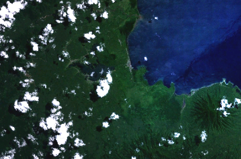 Two cinder cones with circular craters are located above the center of this NASA Landsat image of northern Halmahera Island (with north to the top).  The cones lie between Galela Lake and Galela Bay (upper right), with the town of Galela on its shore.  Tarakan Lamo (on the east side of the lake) and Tarakan Itji (to the NW of Tarakan Lamo) have well-formed summit craters 800 and 500 m in diameter and 160 and 125 m deep, respectively.   NASA Landsat 7 image (worldwind.arc.nasa.gov)
