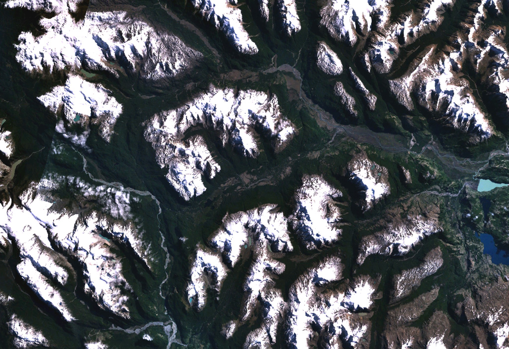 The valley cutting diagonally across the center of this NASA Landsat image (with north to the top) is a tributary of the Río Murta (left) that is partly floored by basaltic lava flows.  The Río Ibáñez cuts across the top of the image.  The flows were emplaced, partly subglacially, in valleys carved by glaciers in granitic rocks of the North Patagonian Batholith in the southern Andes.  The columnar-jointed lava flows of Pleistocene to perhaps Holocene age include pillow lavas, lava tubes, and subglacial and sublacustral deposits.   NASA Landsat 7 image (worldwind.arc.nasa.gov)