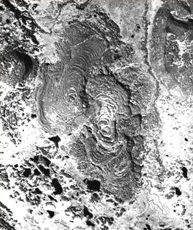 Two closely spaced vents visible near the center of this photo produced the Bliznetsy ("Twins") lava flows. Prominent compressional ridges are visible on the flows, which were dated at about 3,000 years ago. Emplacement of the lava field was preceded by weak phreatomagmatic eruptions. Photo courtesy of  Maria Pevzner (Russian Academy of Sciences, Moscow).