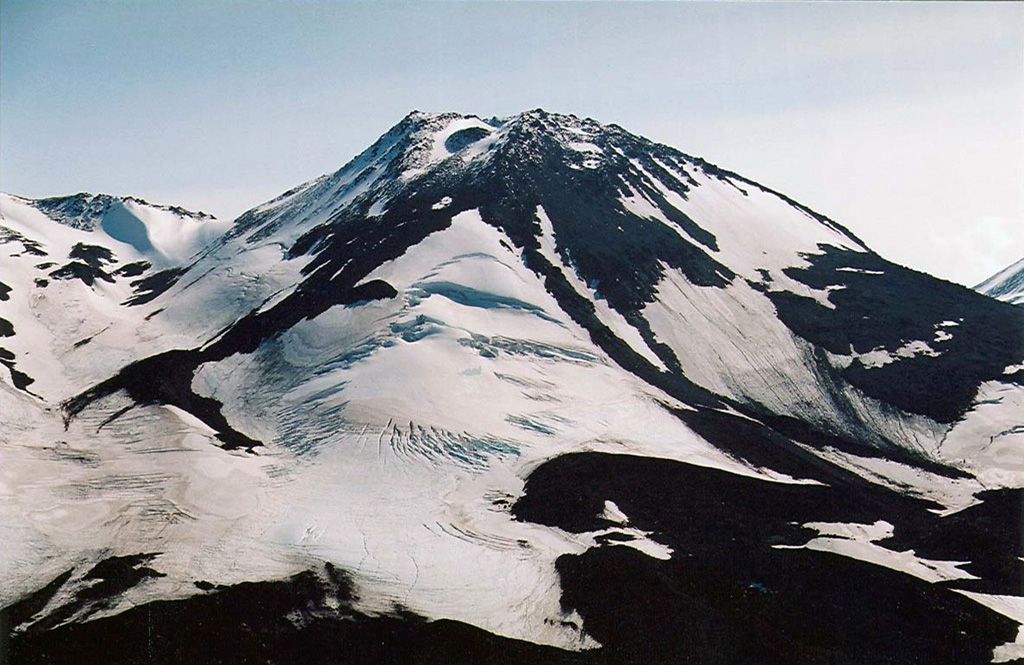 An unnamed scoria cone on the SW flank of Ostry is seen here from the west. Informally referred to as "Cone X," it erupted about 4,000 years ago producing a basaltic lava flow. Copyrighted photo by Maria Pevzner, 2005 (Russian Academy of Sciences, Moscow).