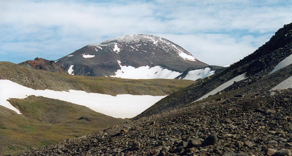 Gorny Institute volcano, seen here from the south, lies at the NE end of chain of small late-Quaternary volcanoes extending NE from Kebeney volcano in the central Sredinny Range. It is one of the large stratovolcanoes in the Sredinny Range that have been active during the Holocene.  Copyrighted photo by Maria Pevzner, 2004 (Russian Academy of Sciences, Moscow).