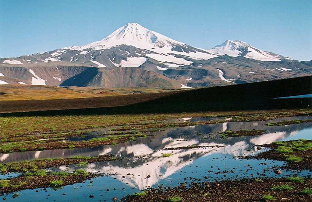 Snow-capped Ostry is seen here from the NW. On the right horizon is an unnamed cone on the SW flank of Ostry, which erupted about 4,000 years ago producing a basaltic lava flow. Copyrighted photo by Maria Pevzner, 2005 (Russian Academy of Sciences, Moscow).