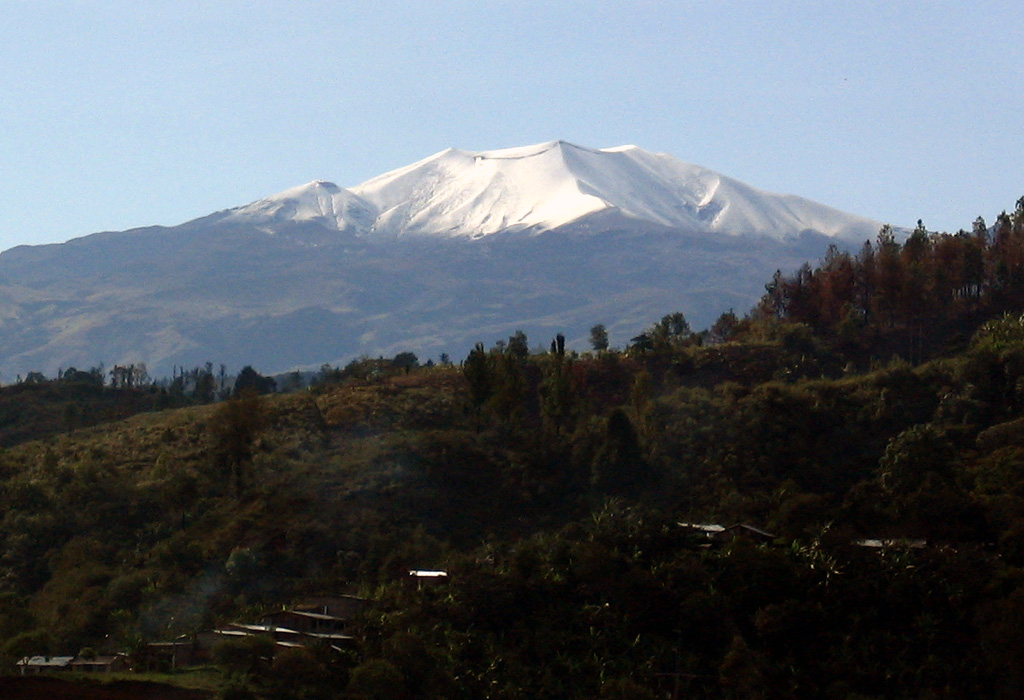 Snow-capped Puracé volcano has a 500-m-wide summit crater and is one of the most active volcanoes in Colombia. Frequent explosive eruptions in the 19th and 20th centuries have modified the morphology of the summit crater, with some of the largest occurring in 1849, 1869, and 1885. Photo by Federmán Escobar Chávez, 2005.