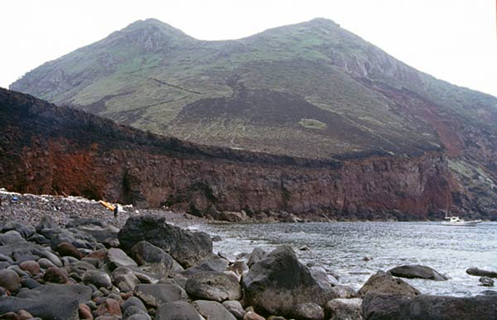 Nishimine, the western peak of Yokoatejima, is seen from the NW with a road visible at the left that reaches the summit crater. Yokoatejima is a small, 3.5-km-long island at the SW end of the Tokara island chain with two peaks, Higashimine to the E and Nishimine to the W. It is a post-caldera cone within a 7 x 10 km submarine caldera. Historical documents at the end of the Edo Period mention ash plumes. Copyrighted photo by Shun Nakano, 2004 (Japanese Quaternary Volcanoes database, RIODB, http://riodb02.ibase.aist.go.jp/strata/VOL_JP/EN/index.htm and Geol Surv Japan, AIST, http://www.gsj.jp/).