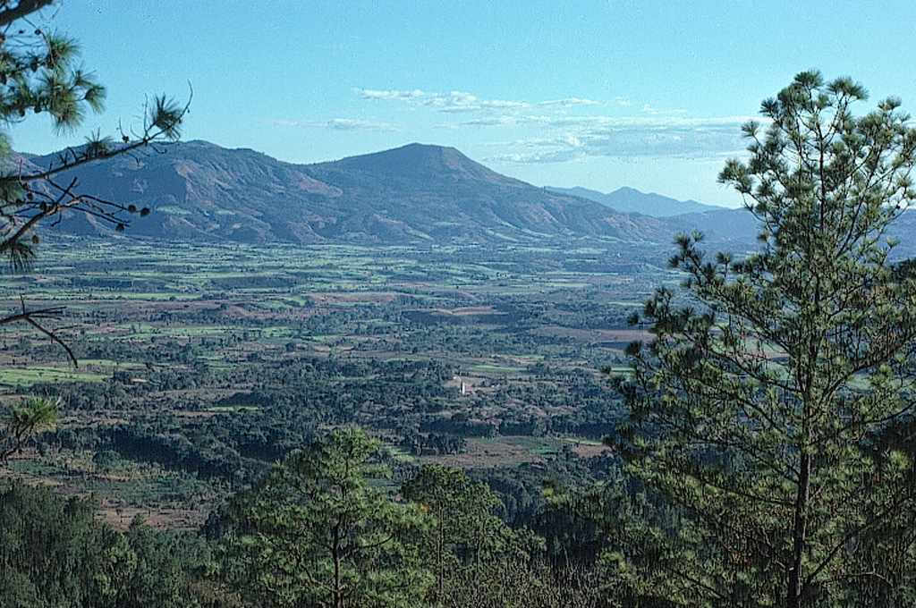 Jumaytepeque, on the center horizon, was constructed near the SE rim of a caldera, and is possibly Holocene. The volcano on the far horizon is Ixhuatán. Photo by Jim Reynolds, 1975 (Brevard College).
