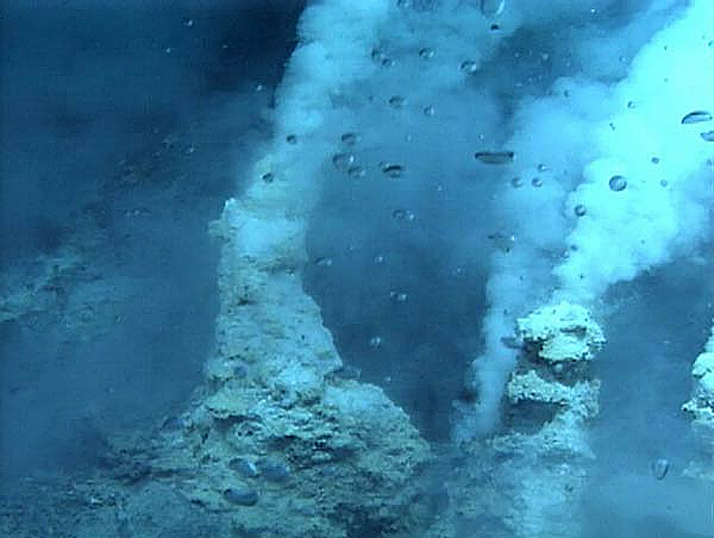 White smokers at NW Eifuku submarine volcano that were photographed by a NOAA expedition in 2006. The bubbles are carbon dioxide; this is one of two places where natural liquid carbon dioxide emission has been observed. It is a small submarine volcano about 1,500 m below the ocean surface that displays vigorous thermal activity. Image courtesy of Submarine Ring of Fire 2006 Exploration, NOAA Vents Program.