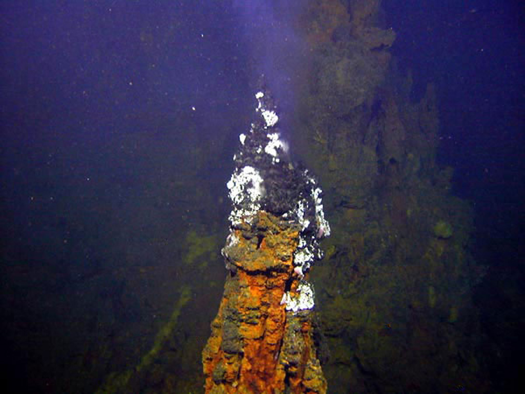 Submarine hydrothermal activity occurs at Brothers volcano, as seen here at this tall (up to 4 m high), active black smoker chimney, which is part of a large field of vents on the NW caldera wall. The oval-shaped caldera is 3-3.5 km wide and contains a post-caldera lava dome constructed on the S caldera floor. Image courtesy of New Zealand-American Submarine Ring of Fire 2005 Exploration, NOAA Vents Program.