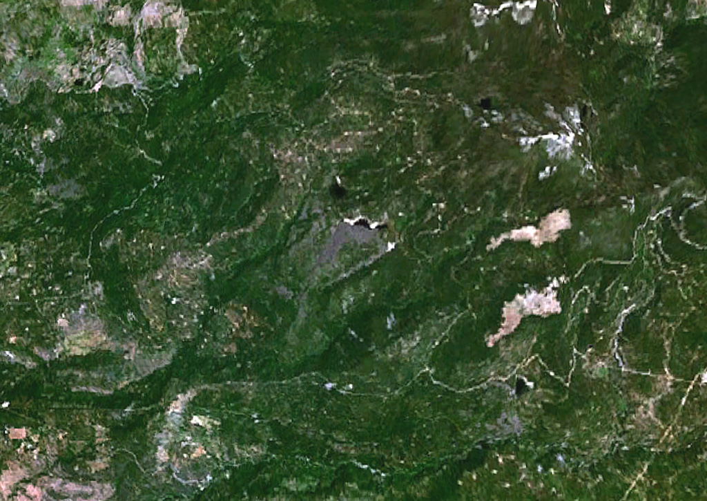 The small grayish area at the center of this NASA Landsat image is a lava flow from the Silver Lake cinder cone.  Lava flows from the cone dammed up drainages, forming two small black-colored lakes, Silver Lake and Arthur Lake.  Another small dark-colored lake at the lower right, south of the two large elongated light-colored areas, was formed when lava flows from the Buckhorn Lake cinder cone blocked a stream valley. NASA Landsat 7 image (worldwind.arc.nasa.gov)