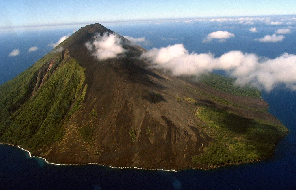Lopevi is seen here in an aerial view from the NW, with lava flows that erupted from NW-SE-trending fissures forming the barren slopes in the foreground. The small 7-km-wide island is known locally as Vanei Vollohulu. Historical eruptions date back to the mid-19th century. The island was evacuated following major eruptions in 1939 and 1960.  Photo by Karoly Nemeth, 2005 (Massey University).