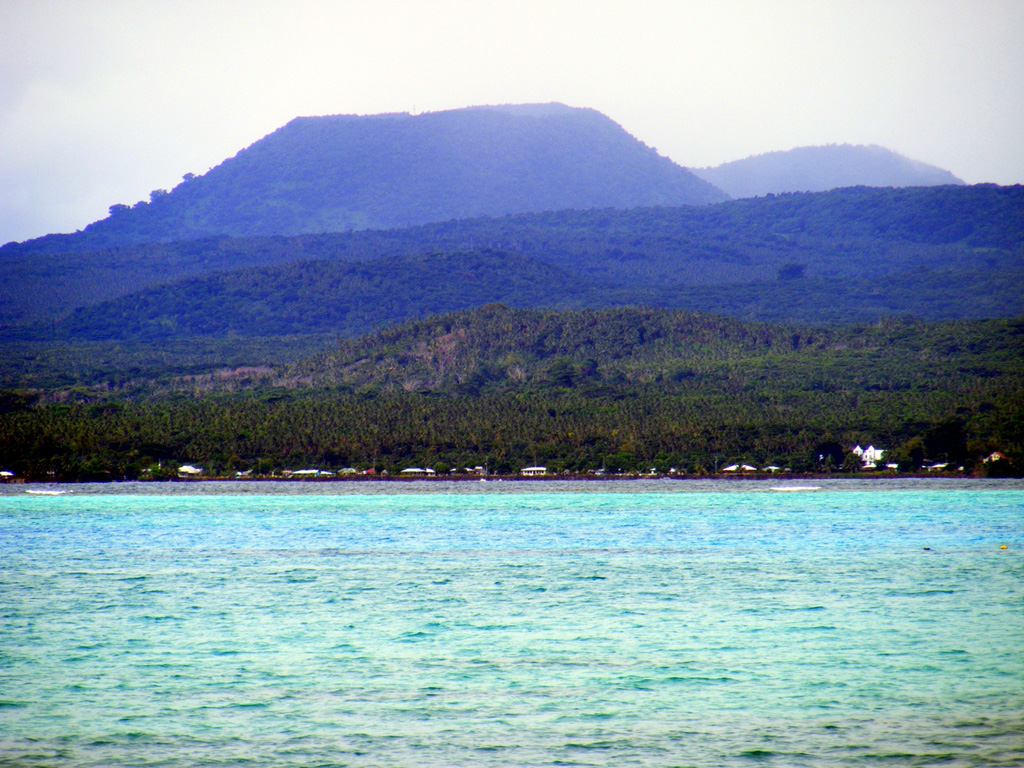 The forested scoria cone of Tafua Upolu rises near the western tip of 75-km-long Upolu Island in Samoa. The shield volcano is elongated in an E-W direction and was constructed during two periods of extensive eruptions during the Pliocene and Pleistocene. Following a lengthy period of erosion, the latest lava flows, at least three of which were estimated to be as young as a few hundred to a few thousand years old, were erupted from vents near the crest of the island at its center and western side. Photo by Karoly Nemeth (Massey University).