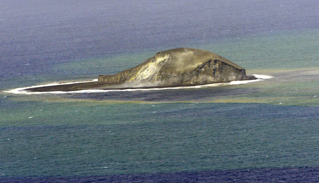 A partially eroded pumice cone formed during an eruption that began on 7 August 2006 is seen from the N on 18 December. By the end of the year, wave erosion had destroyed the cone. Floating dacite pumice from this eruption traveled as far as Australia. Home Reef, a submarine volcano midway between Metis Shoal and Late Island in the central Tonga islands, was first reported active in the mid-19th century, when an ephemeral island formed. Photo courtesy of Royal New Zealand Air Force and Institute of Geological & Nuclear Sciences, 2006.