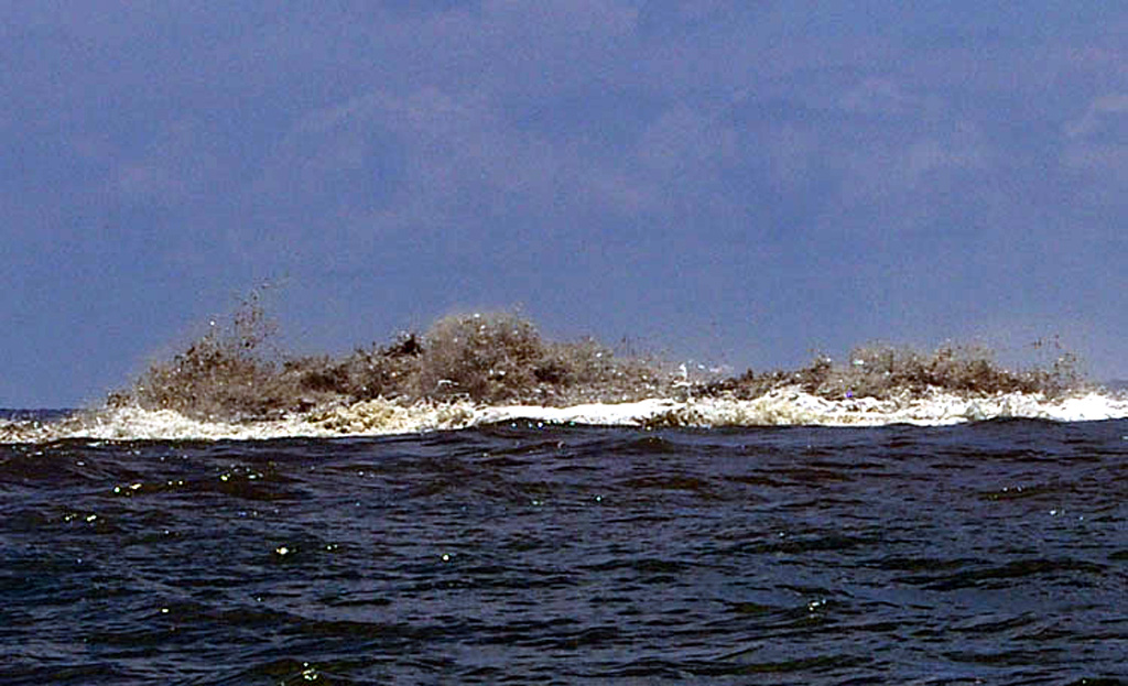 Some of the stronger activity observed at Kavachi on 6 April 2007 included turbulent ash-laden water above the vent, audible explosions, and discolored water down-current of the vent. Following 2 April 2007 Kavachi emitted an ash plume visible from Biche village (on the S coast of Nggatokae Island). Photo by Roy Hall, 2007.