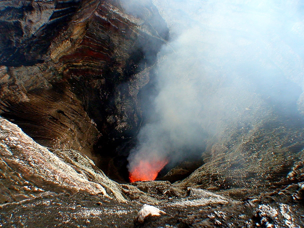 A lava lake is visible inside Mbwelesu crater within Marum cone at Ambrym on 7 June 2007. Lava lake activity was observed during a field expedition from May to June. MODIS thermal alerts had resumed at Ambrym since November 2006 and eruptions took place in April and March 2007. Photo by Steven Clegg, 2007.