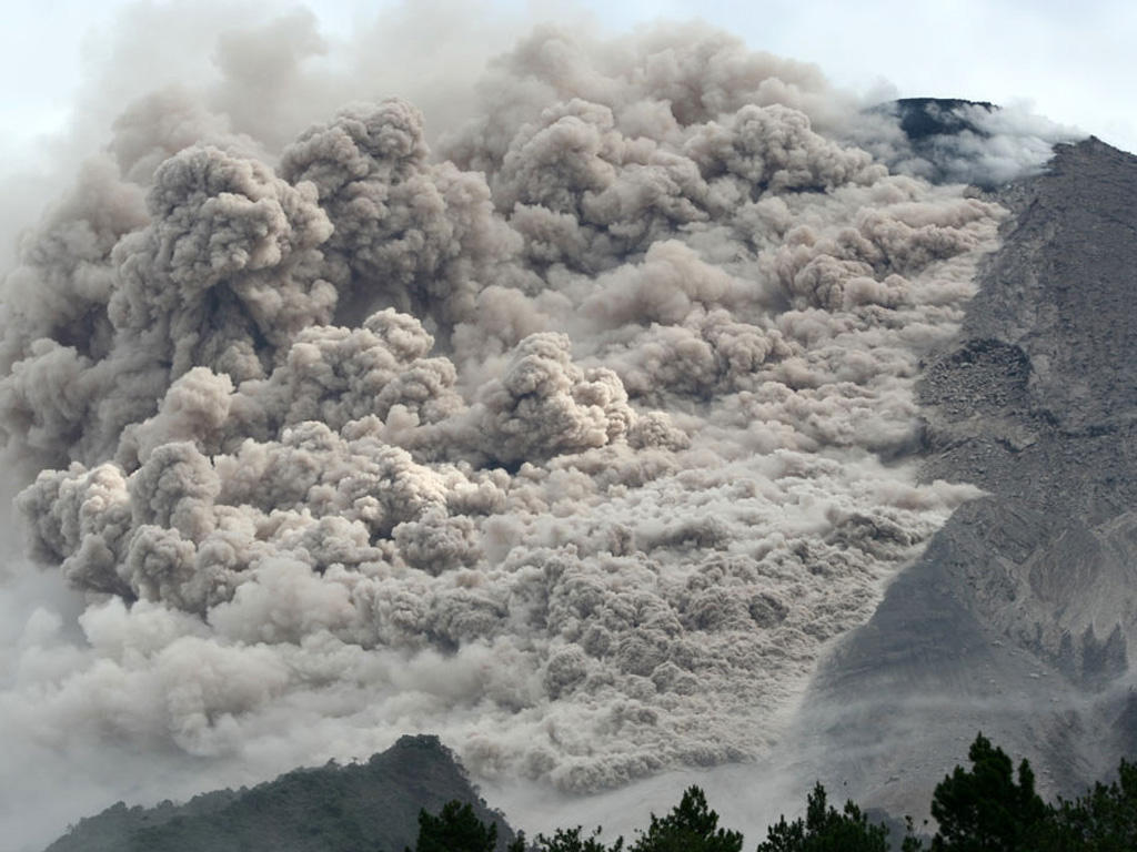 A pyroclastic flow travels down the SE flank of Merapi on 7 June 2006. Renewed lava dome growth had begun at Merapi in April 2006. Ashfall was reported 5 km from the summit on 27 April. Beginning in May, pyroclastic flows descended the flanks of the volcano, sometimes reaching populated areas. Photo courtesy of The Research and Technology Development Agency for Volcanology, Yogyakarta (BPPTK), 2006.