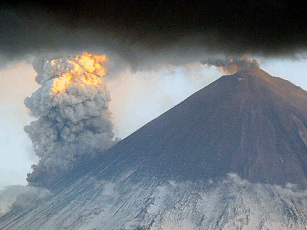 Klyuchevskoy is seen from the north on 31 May 2007, showing an ash plume from the summit crater and a larger steam plume rising from the eastern flank where lava flows were interacting with snow and ice. Photo by Yu. Demyanchuk, 2007 (KVERT).