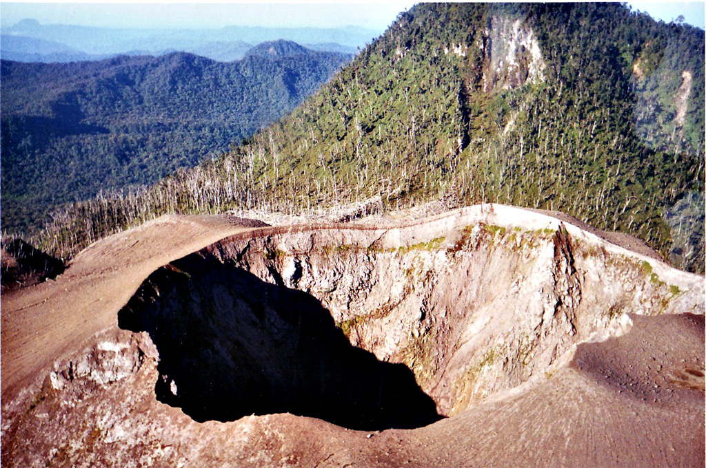 The summit crater of Peuet Sague is part of a large volcanic complex in NW Sumatra. The first recorded historical eruption took place during 1918-21, when explosive activity and pyroclastic flows accompanied summit lava-dome growth. The historically-active crater has typically produced small-to-moderate explosive eruptions. Copyrighted photo by Michael Thirnbeck, 1997.