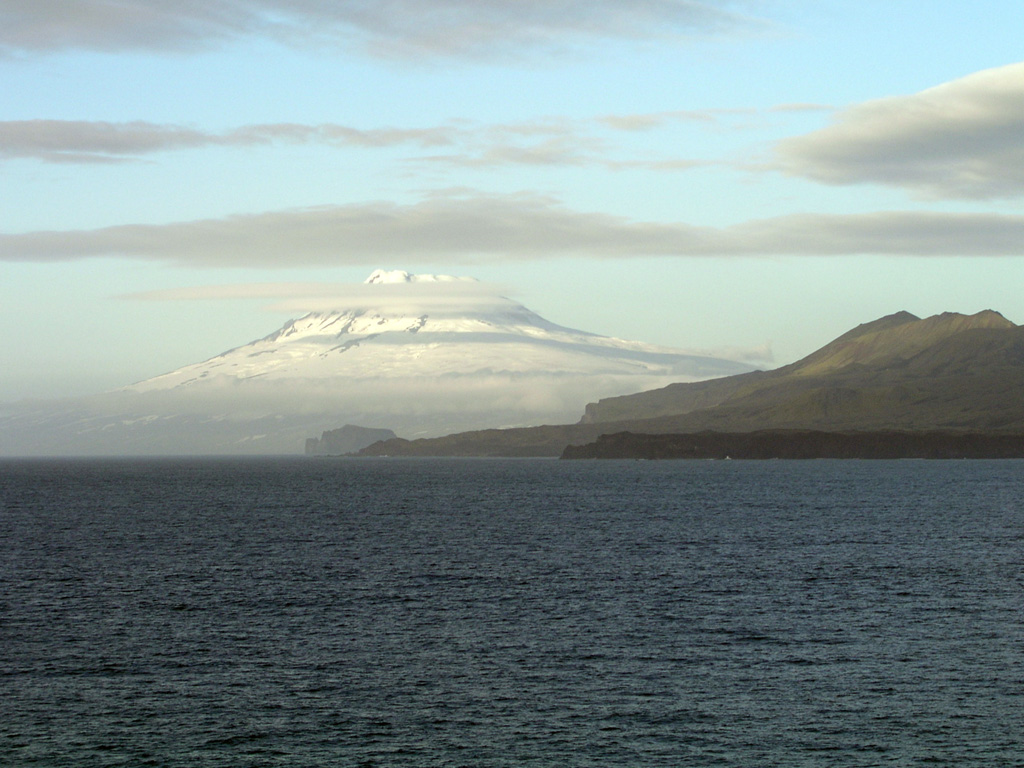 Glacier-covered Beerenberg volcano rises above the western coast of Jan Mayen at the northern end of the island. This remote island in the Norwegian Sea along the Mid-Atlantic Ridge about 650 km NE of Iceland consists of two volcanic complexes separated by a narrow isthmus. The Beerenberg stratovolcano has a 1-km-wide summit crater and numerous flank cinder cones. Reported eruptions from Beerenberg date back to the 18th century. Photo by Gernot Hecker, 2005 (Wikimedia Commons).