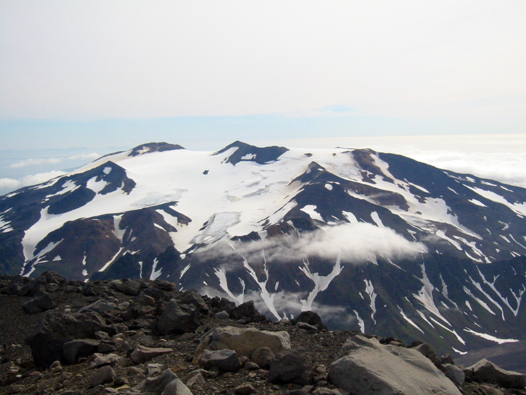 Takawangha is seen here looking E from the summit of East Tanaga. It lies across a saddle from historically active Tanaga volcano to the west. The summit has five Holocene craters that produced explosive eruptions and lava flows that reached the lower flanks during the last few thousand years.  Photo by Michelle Coombs, 2003 (Alaska Volcano Observatory, U.S. Geological Survey).