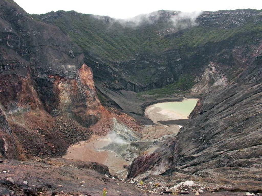 A small lake occupies the steep-walled summit crater of Cereme volcano in central Java in this 2004 view. The symmetrical stratovolcano is located closer to the northern coast than other central Java volcanoes. Eruptions have included explosive activity and lahars, primarily from the summit crater. Photo by Cahya Patria, 2004 (Centre of Volcanology & Geological Hazard Mitigation, Volcanological Survey of Indonesia).