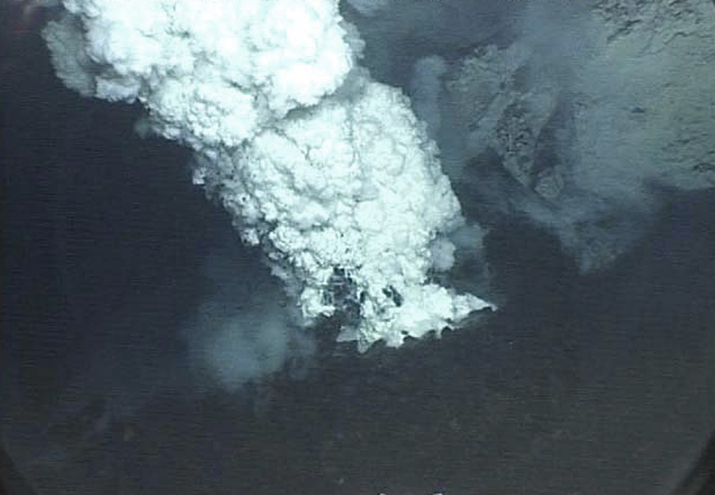 An eruption plume rises from a submarine vent on NW-Rota 1 volcano on 27 April 2006. This volcano was first detected during a 2003 NOAA bathymetric survey of the Mariana Island arc. The seamount rises to within about 500 m of the sea surface SW of Esmeralda Bank. During subsequent visits in 2005, 2006, and 2008, the volcano was seen to be in eruption. Courtesy of Bill Chadwick, 2006 (Oregon State University/NOAA).