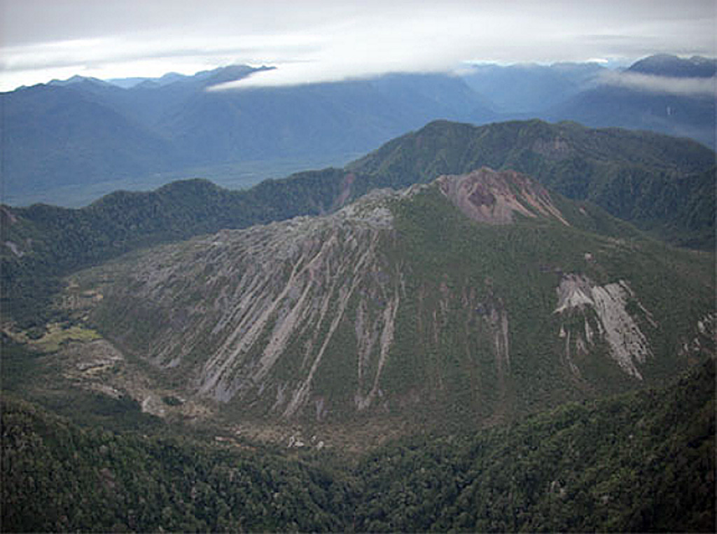 The dome-filled caldera of Chaitén volcano is seen in an aerial view from the south taken prior to an eruption in 2008.  The volcano is located 10 km NE of the town of Chaitén on the Gulf of Corcovado.  The elliptical 2.5 x 4 km wide summit caldera was formed during an eruption dated at about 9400 years ago.  A rhyolitic, 962-m-high obsidian lava dome occupies much of the caldera floor.   Photo by Eric Manríquez T. (Instituto Geográfico Militar).
