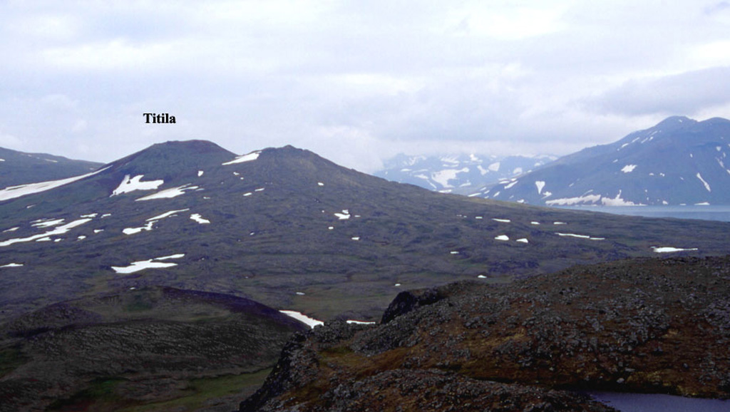 Titila volcano is viewed looking towards the SE. It started to erupt in the late Pleistocene and was active about 10,000-8,000 and 3,000-2,500 years ago. A flank vent (forming the peak to the right) formed during the early Holocene. Its lava flows dammed a river to form Glubokoye Lake to the right. Copyrighted photo by Maxim Portnyagin (Holocene Kamchataka volcanoes; http://www.kscnet.ru/ivs/volcanoes/holocene/main/main.htm).