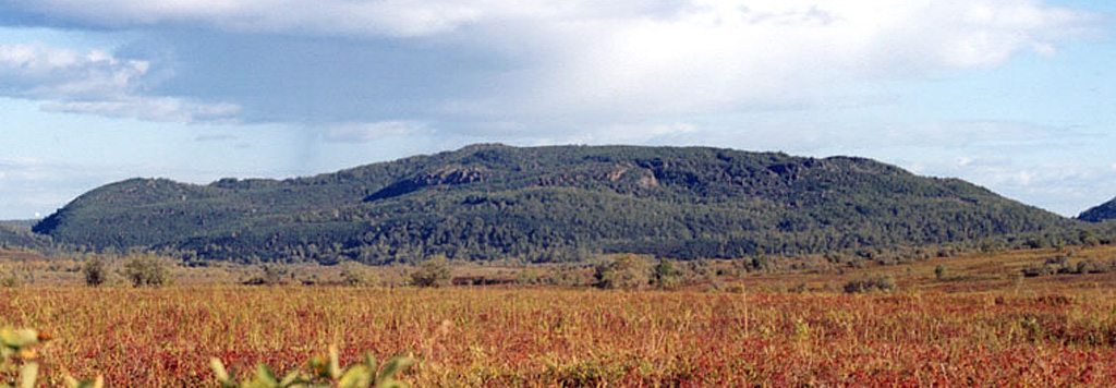 The Shisheika lava dome, seen here from the west, is located to the west of the Sredinny Range, near the mouth of the Shishei River. The eruption occurred about 4,000 years ago and began as a minor explosive eruption that dispersed tephra to around 20 km from the source.  Copyrighted photo by Maria Pevzner (Holocene Kamchataka volcanoes; http://www.kscnet.ru/ivs/volcanoes/holocene/main/main.htm).