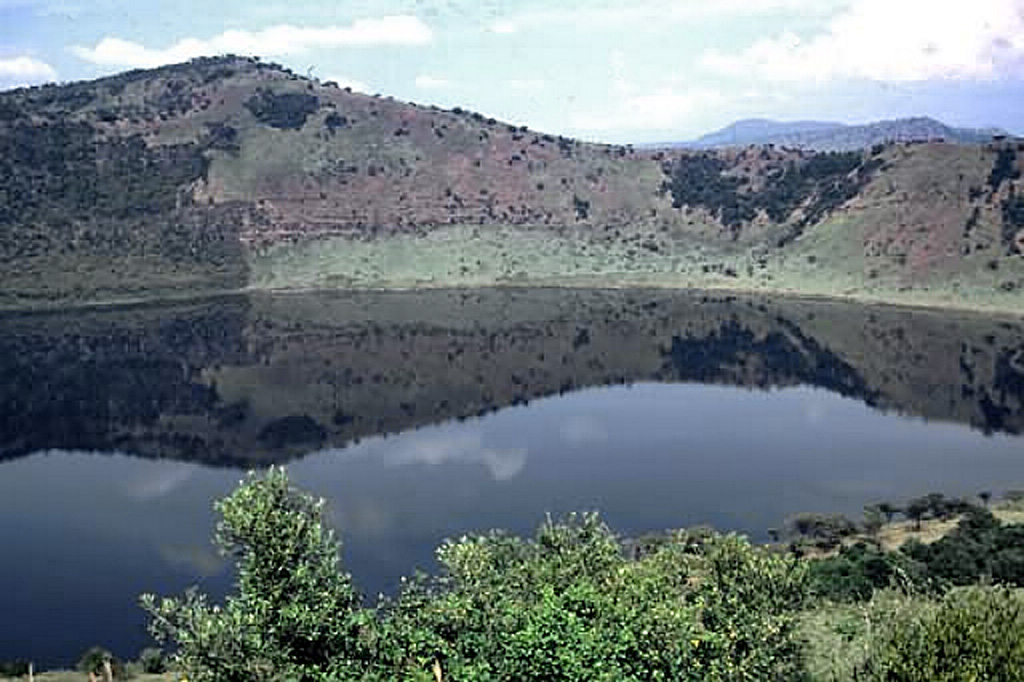 This lake-filled crater is part of the Katwe-Kikorongo volcanic field that stretches from the NE shore of Lake Edward to the western shore of Lake George. It is the most extensive of a series of volcanic fields in the Western Rift Valley of Uganda containing carbonatitic cones and maars, some of which contain lakes. Local stories suggest that volcanism in the area has continued into historical times. Photo by Nelson Eby (University of Massachusetts).