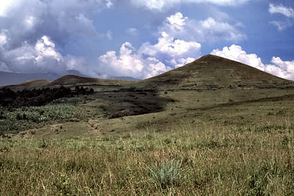 These grass-covered tuff cones are among the many of the Fort Portal volcanic field in Uganda. The carbonatite lavas and tuffs were erupted from about 50 cones and maars, some of which now contain crater lakes.  Photo by Nelson Eby (University of Massachusetts).