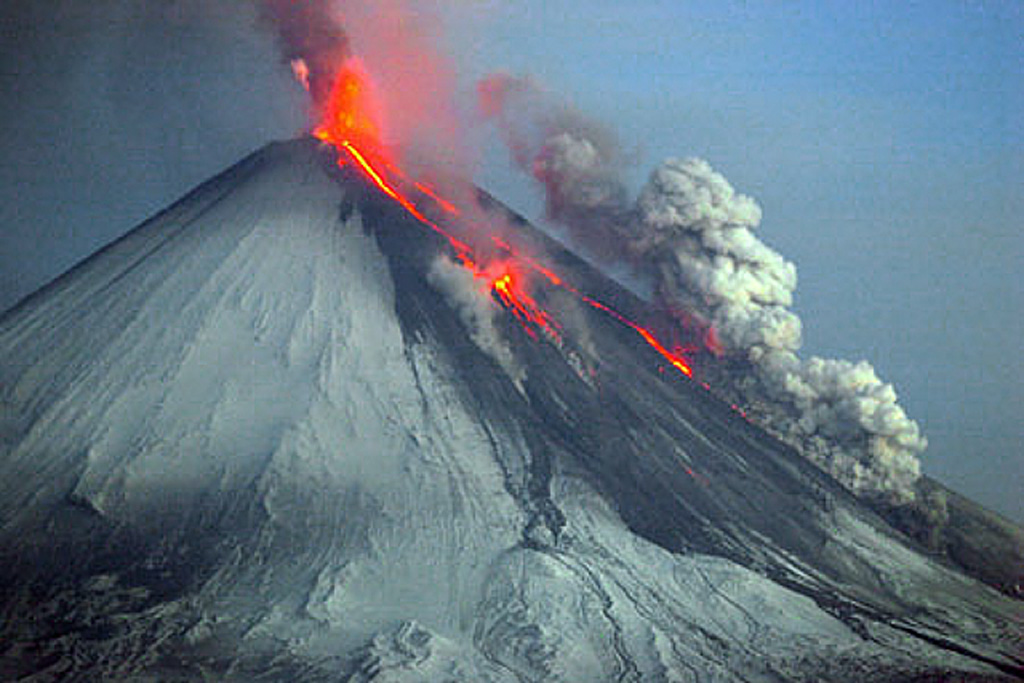 Strombolian eruptions produce incandescent plumes from the summit crater and lava flows descend the NW flanks of the volcano on 27 May 2007 and an ash-and-steam plume rises from the lava flow margins. Strombolian eruptions had begun on 15 February 2007 at the summit crater. Intermittent explosive activity continued, and lava flows began traveling down the NW flank on 29 March. Steam-and-ash plumes reached a maximum altitude of 10 km on May 27 and the last ash plume was observed on 15 July, after which steam plumes were observed. Photo by Yu. Demyanchuk, 2007 (KVERT).