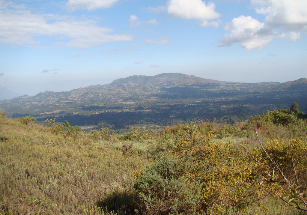 The Kyejo volcanic complex (also spelled Kieyo) is seen from Katete, an eroded volcano located 10-15 km to the NNW. Late-stage activity consisted of the formation of numerous maars and cones. The latest eruption around 1800 CE took place from two cones that were constructed along a NW-trending fissure: Sarabwe and Fiteko. The eruption produced lava flows that overran several villages. Photo by Karen Fontijn, 2008 (University of Ghent).