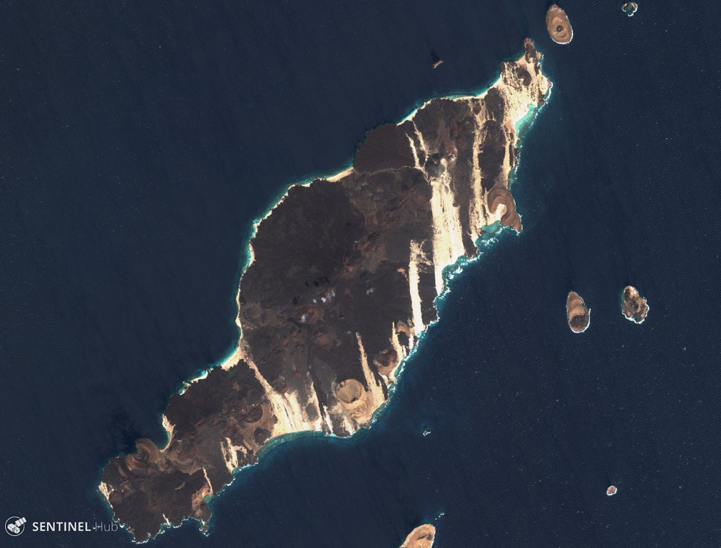 The 18-km-long island of Hanish is seen in this 3 December 2019 Sentinel-2 satellite image (N is at the top). Scoria cones and tuff cones are visible along with lava flows that have reached the coasts on all sides of the island. This island has formed during explosive phreatic eruptions with magma-water interactions, and magmatic eruptions producing lava flows. This island is approximately 18 km in the NE-SW direction. Satellite image courtesy of Copernicus Sentinel Data, 2019.