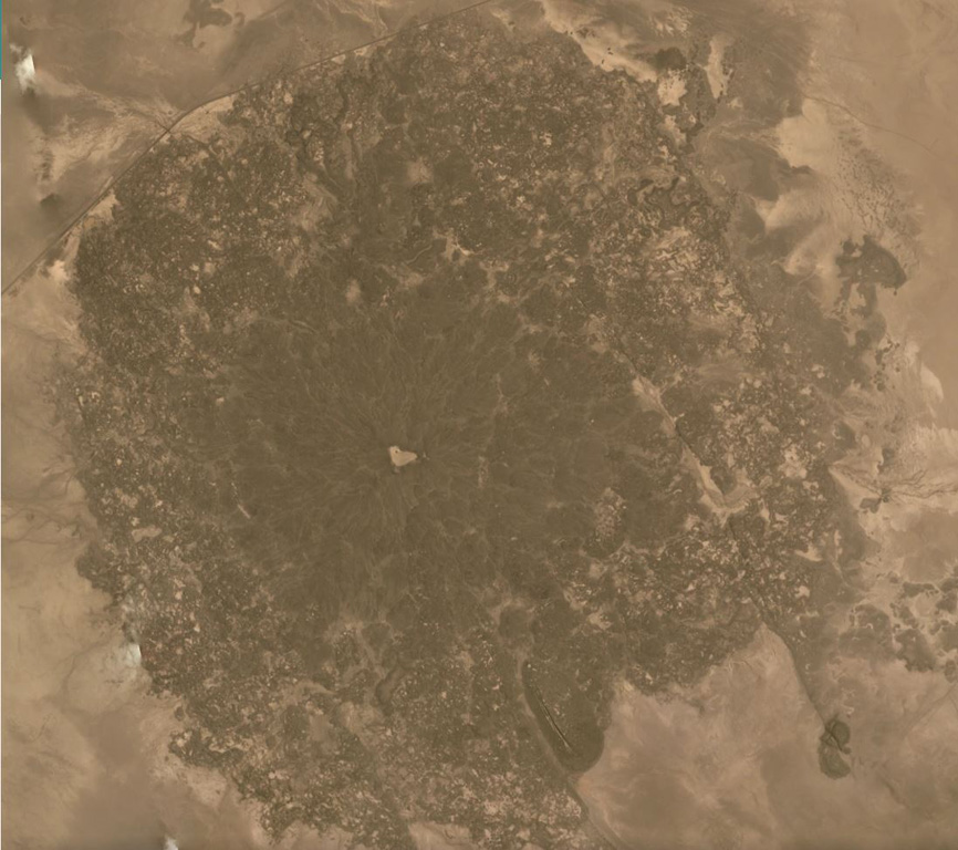 The Kurub edifice covers much of this May 2019 Planet Labs satellite image mosaic (N is at the top), with the darker area approximately 9 km in diameter. This broad area is composed of lava flows and vents, with sand filling the central crater. It is located south of Erta Ale, within the Saha Plain of Ethiopia. Satellite image courtesy of Planet Labs Inc., 2019 (https://www.planet.com/).