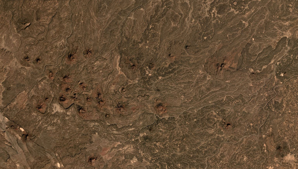 The Gufa volcanic field NE of Mousa Alli volcano extends from the Djibouti border (bottom left) into Eritrea, seen here in this December 2019 Planet Labs satellite image mosaic (N is at the top; this image is approximately 23 km across). Many scoria cones and lava flows are visible withing the broad field aligned in an E-W direction. Satellite image courtesy of Planet Labs Inc., 2019 (https://www.planet.com/).