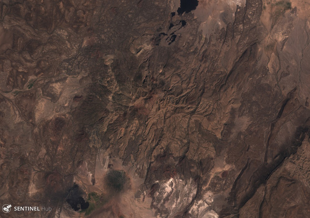 Yangudi is a large eroded volcano in the Addado graben of the northern Ethiopian rift, seen here in this 15 November 2019 Sentinel-2 satellite image (N is at the top; this image is approximately 20 km across). The darker areas to the N and S are more recent lava flows and scoria cones, and numerous NNE-SSW-trending faults of the Ethiopian Rift are visible. Satellite image courtesy of Copernicus Sentinel Data, 2019.