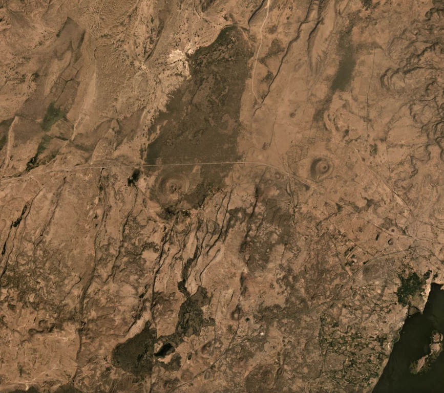 Beru comprises an area of Holocene basaltic scoria cones and lava flows located along the Main Ethiopian Rift between Fentale volcano to the upper right and Kone to the lower left. Several scoria cones are visible in this  November 2019 Planet Labs Satellite image Monthly Mosaic (N is at the top; this image is approximately 21 km across). The lake to the lower right is Basaka, whose northern shoreline was formed by a young lava flow from a Fentale flank vent. Satellite image courtesy of Planet Labs Inc., 2019 (https://www.planet.com/).