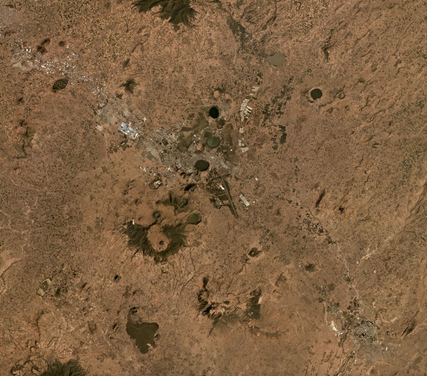 Bishoftu Volcanic Field is a monogenetic volcanic field containing tuff rings, scoria cones, lava flows, domes, and maars within the Ethiopian Rift Valley SE of Addis Ababa, seen here in a December 2019 Planet Labs satellite image monthly mosaic (N is at the top; this image is approximately 40 km across). The town of Bishoftu has developed within the field. Lakes such as Bishoftu, Hora, Kiroftu, and Bishofta Guda have formed within maar craters. Satellite image courtesy of Planet Labs Inc., 2019 (https://www.planet.com/).