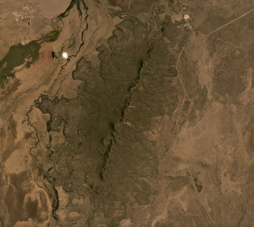 The Korath Range is the northernmost volcano of the Turkana rift in southern Ethiopia/northern Kenya. The central lineament of cones and craters has produced lava flows out to around 6 km from the vents. This September 2019 Planet Labs satellite image monthly mosaic shows the lobate flow margins and lateral flow levees and margins (N is at the top; this image is approximately 20 km across). Satellite image courtesy of Planet Labs Inc., 2019 (https://www.planet.com/).